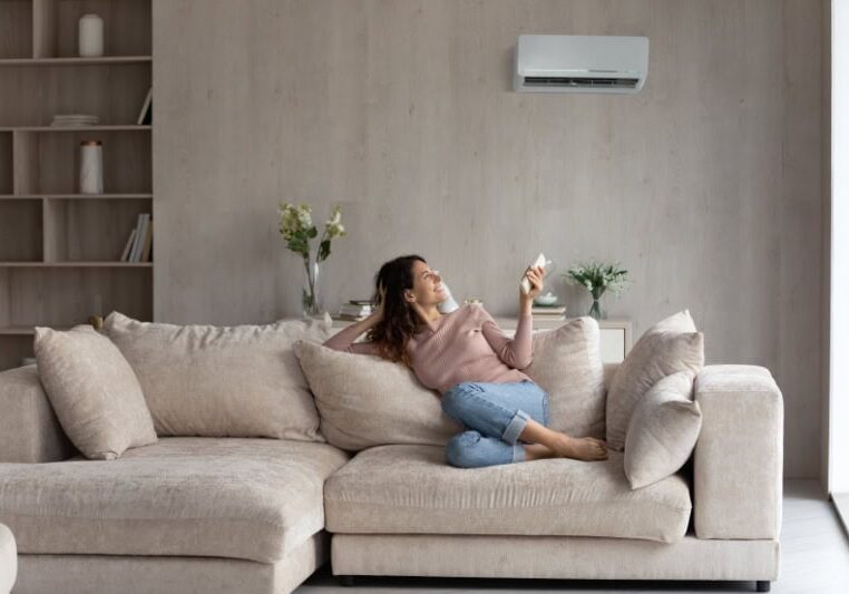 Planning to Remodel? Go Ductless! Relaxed young hispanic female homeowner sitting on huge comfortable couch
