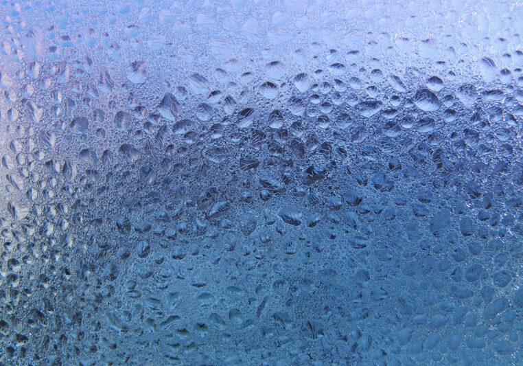 Water drops and frost on window glass