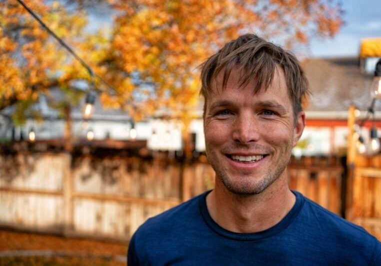 Preparing Your HVAC System for the Fall - Man in Front of Fall Backdrop.